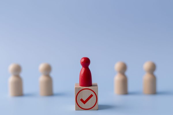 Business hiring and recruitment selection. Career opportunity. H Business hiring and recruitment selection. Career opportunity. Human Resource Management. red human icon standing on a checkmark. Choice of employee leader from the crowd.