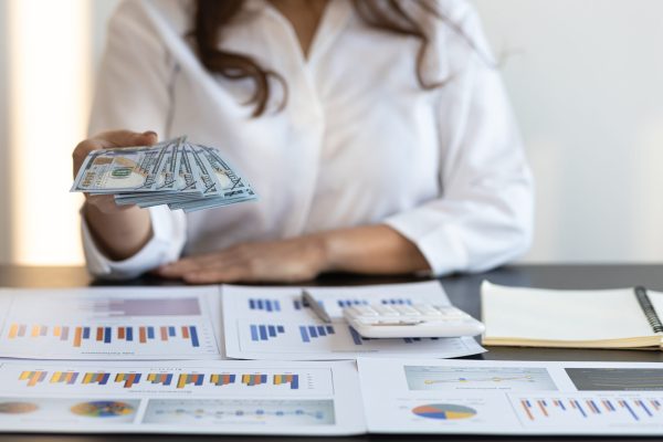 woman-holding-money-and-banknotes-cash-is-offerin-2023-11-27-05-04-09-utc Woman holding money and banknotes, cash is offering to you. Wage payment concept.